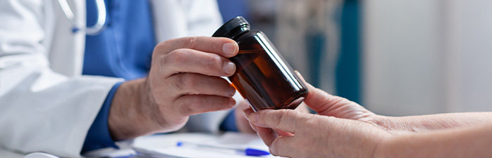 Pharmacist giving customer medication